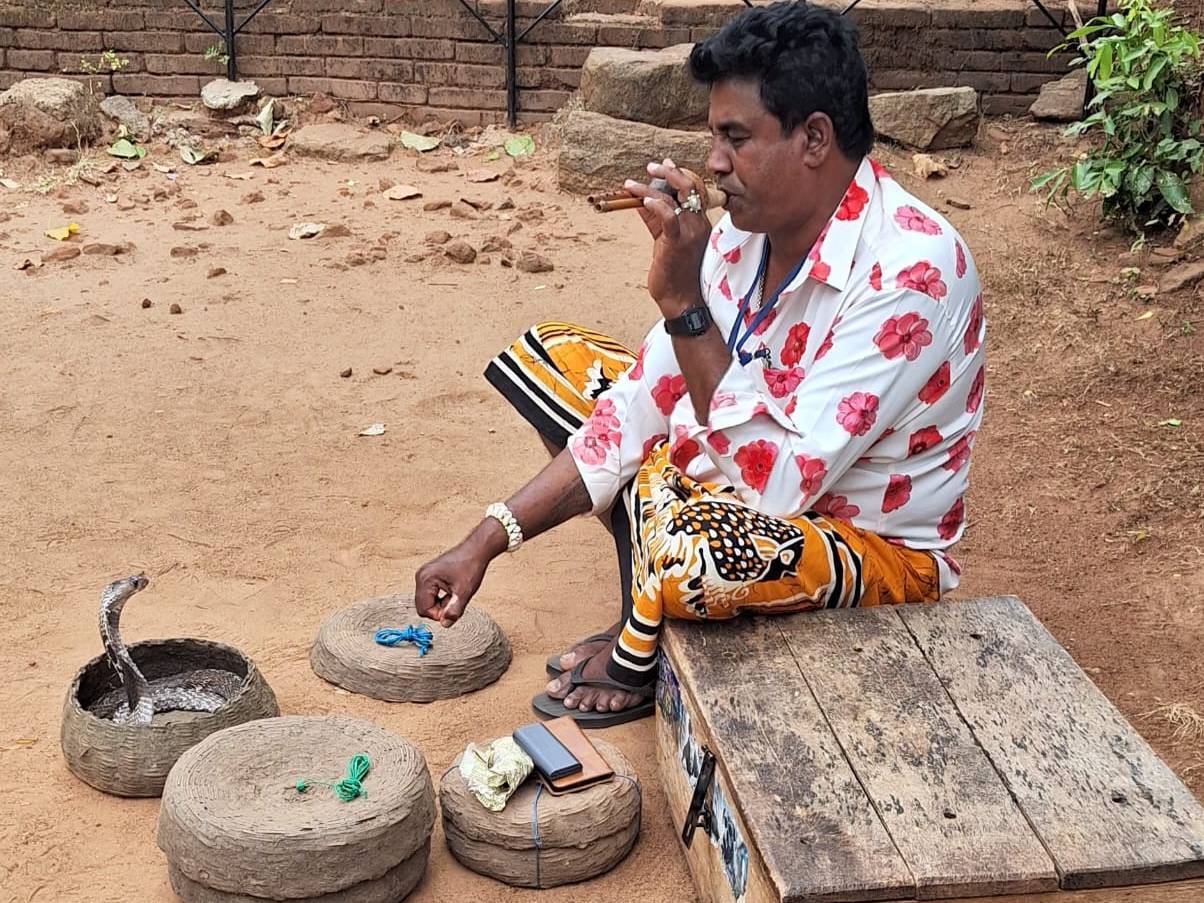 A traditional snake charmer performing on the street in Sri Lanka.